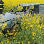 Žena s autem metala kozelce v řepce